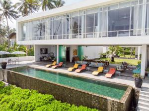 an exterior view of a house with a swimming pool at Sielen Diva in Unawatuna