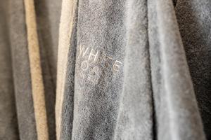 a close up of a gray curtain with a label at Domes White Coast Milos, Adults Only - Small Luxury Hotels of the World in Mytakas