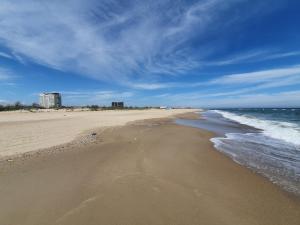 a beach with the ocean and buildings in the background at Light room Затока in Zatoka +3 photos