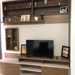 a living room with a large flat screen tv at Recanto Ribas in Ubatuba