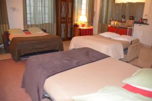 En eller flere senge i et værelse på La Maison d'Anne