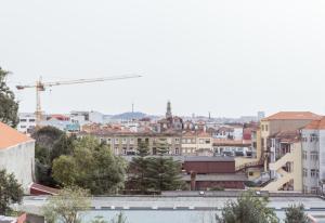 a view of a city with a crane at Casa do Mirante in Porto