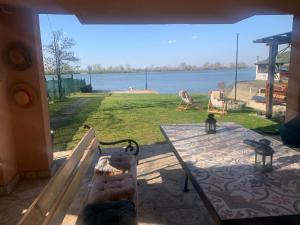a patio with a table and a view of the water at Dunavska Kuća in Smederevo