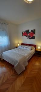 a bedroom with a bed and a wooden floor at Apartmani Nikica in Drage +24 photos