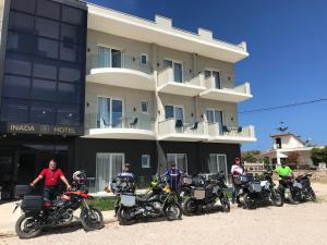 a group of motorcycles parked in front of a building at Inada Hotel Ksamil in Ksamil