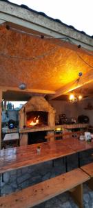 a wooden table with a pizza oven in a room at Apartmani Nikica in Drage