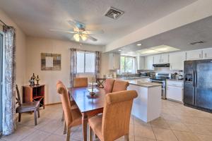 a kitchen and dining room with a table and chairs at Lake Havasu Home with Heated Pool about 1 Mi to Water in Lake Havasu City