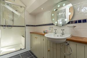 a bathroom with a sink and a shower at Theaked Stones in Leyburn +35 photos