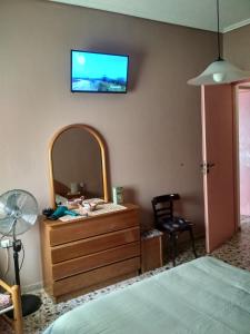 - une chambre avec une commode et une télévision murale dans l'établissement Two-Bedrooms Apartment in Center of Rethymno, à Réthymnon