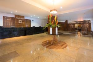 a large room with a large vase with flowers in it at Hotel Habitel Select in Bogotá