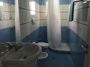 a bathroom with a sink and a toilet at Apartment Alexis Stefanos in Himare