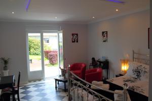 a bedroom with a bed and a sliding glass door at Le Potier Jovial in Ger