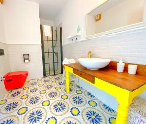 a bathroom with a sink on a tile floor at Kesre Hotel in Alaçatı +26 photos
