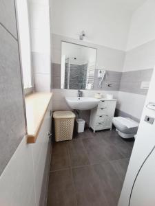 a bathroom with a sink and a toilet and a mirror at La Casa di Fiore in Avezzano