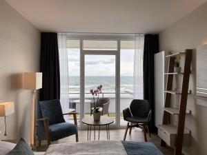 a bedroom with a room with a view of the ocean at Hotel Thode in Dahme