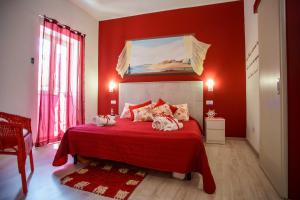 a red bedroom with a bed with red walls at La casa del pescatore in Oliveri
