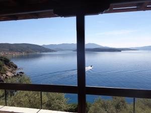 a view of a lake from a window at Sea Front in Milina