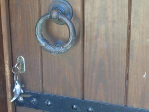 a metal door handle on a wooden door at Sea Front in Milina
