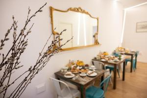 a dining room with wooden tables and a mirror at Ai Tre Mercati in Palermo