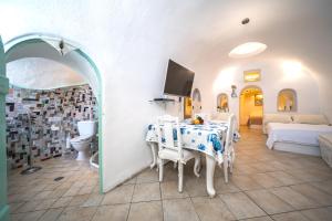 a living room with a table and a couch at Santorini Paradise Cave Houses in Oia