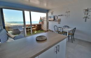 a kitchen and living room with a view of the ocean at Appartement Valras 1ere ligne vue mer in Valras-Plage