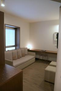 a living room with a couch and a table at Hotel Carla in Levanto