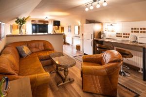 a living room with a couch and a kitchen at PelsoArt Apartments in Keszthely