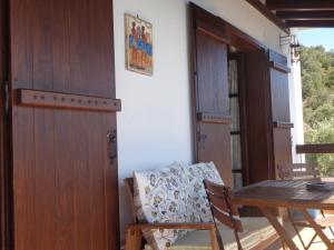 a room with a wooden door and a table and chairs at Sea Front in Milina
