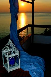 a view of a boat with the sunset in the background at Sea Front in Milina