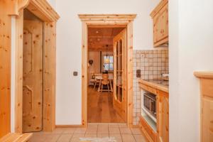 a kitchen with wooden cabinets and a table at Gschwendtnerhof App8 Fuß in Aschau im Chiemgau