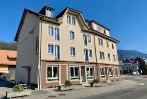 a large building on the side of a street at Monteurzimmer - Worker's accommodation - ZIMMERzuVERMIETEN in Lengnau BE in Lengnau