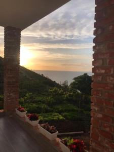 a view of the ocean from the balcony of a house at Grand Seaview Apartments in Ksamil