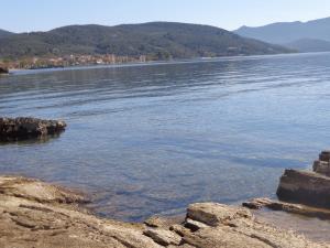 a large body of water with mountains in the background at Sea Front in Milina