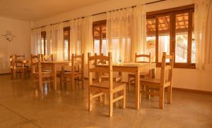 a dining room with wooden tables and chairs at Pousada Cheiro da Terra - Sem Café da Manha in Capitólio