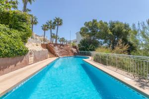 a swimming pool with blue water and trees at Appartement Altamira Orihuela Costa Golf, Las Ramblas in Orihuela Costa