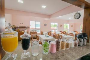 a table with glasses of drinks on a counter in a restaurant at Pousada Baía dos Açores in Penha