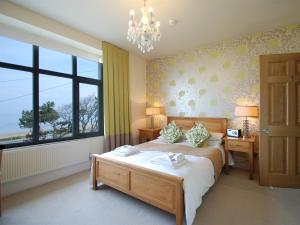 a bedroom with a bed and a large window at The Gladstone in Conwy