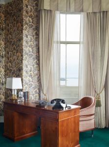 a desk and a chair in a room with a window at Marine North Berwick in North Berwick