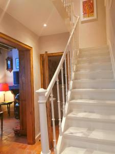 a staircase in a home with a white stair case at Old Bruges B&B in Bruges