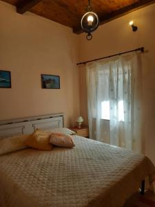 a bedroom with a bed with a white comforter and a window at Astoria Tropea Centro storico in Tropea