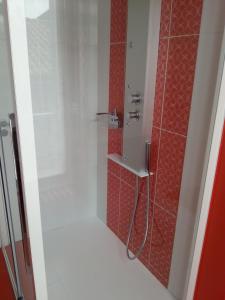 a bathroom with a shower with red tile at La Maison d'Adelaïde Chambres d'hôtes in Saint-Flour +19 photos
