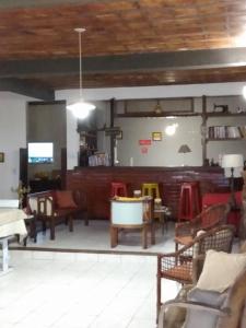 a living room filled with lots of furniture at Pousada da Barra in Barra de São João