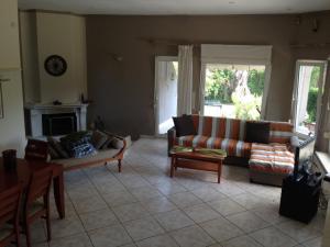 a living room with two couches and a fireplace at House with Garden in Nea Peramos