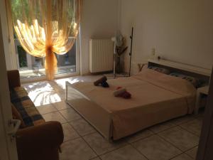 a bedroom with a bed and a large window at House with Garden in Nea Peramos