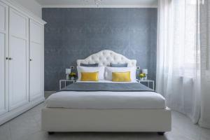 a bed in a bedroom with a white bedspread at Ca del Mar Venice Luxury Apartments in Venice