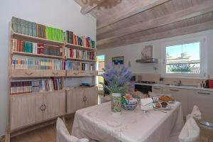 eine Küche mit einem Tisch und einer Blumenvase darauf in der Unterkunft La casa del pittore in Olbia