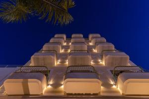a row of beds on a cruise ship at night at Leonardo Boutique Hotel Larnaca in Larnaca