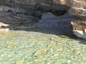a pool of water with rocks in a cave at Sea Front in Milina