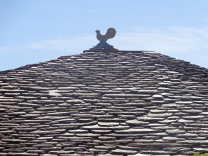 a bird sitting on the top of a roof at Sea Front in Milina