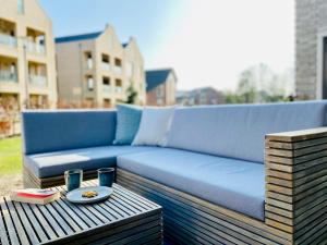 a blue couch sitting on a table on a patio at Apartment Waterkamp, 26316 Dangast in Dangast